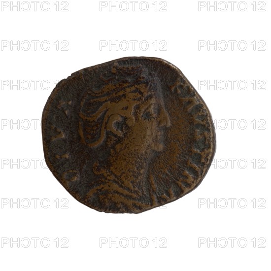 Dupondius/as; Faustina the Elder 98–141; Roman empress 138–141 posthumous; Antoninus Pius 86–161; Roman emperor 138–161 issuer. Obverse: Bust of Faustina I in drapery facing right, legend DIVA FAVSTINA. Reverse: Aeternitas standing left; in his outstretched right hand he holds a globe with a phoenix, with his left hand he raises the hem of his robe; legend AETERNITAS, in SC. Minted after 141, Rome, Roman Empire. Bronze coin; diameter 22.0–24.5 mm, weight 10.00 g, axis 180°., A round, worn coin with an uneven edge displaying a raised profile of a person's head in relief, shown in profile facing right; the surface has textured, irregular areas with visible wear and shallow grooves. The coin shows a mix of dark brown and lighter brown tones across its surface, with some almost blackened patches and subtle variations in sheen where the raised details catch the light. The background is plain white.