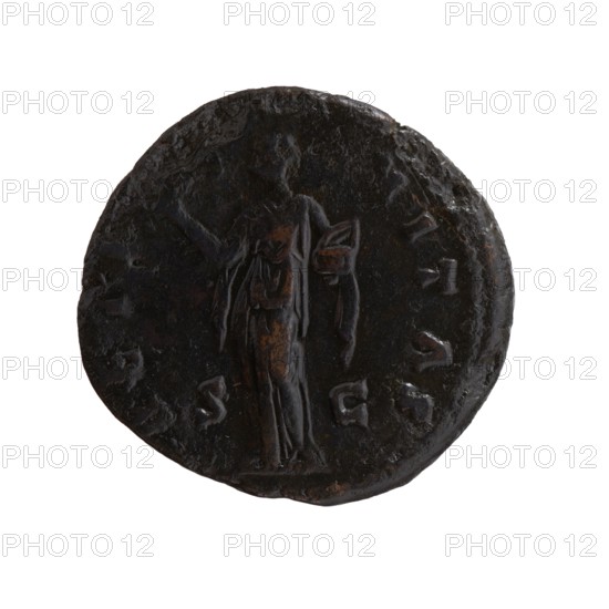 Dupondius/as, Faustina the Elder 98–141; Roman empress 138–141 posthumous, Antoninus Pius 86–161; Roman emperor 138–161 issuer. Bronze coin dupondius/as, Rome, after 141 CE. Obverse: Bust of Faustina I in drapery facing right, legend DIVA·FAVSTINA. Reverse: Pietas standing left, right hand outstretched, holding an incense container in the left; legend AETERNITAS in exergue, mint mark SC. Diameter 26.0–27.0 mm; weight 10.65 g; axis 165°., A round dark metallic object with an uneven edge showing a worn, textured surface and a slightly raised central figure of a standing person draped in flowing garments, holding a small rectangular or folded item in one hand while the other arm is extended; the surface shows areas of brownish wear against the overall black or dark brown patina, with several shallow indented marks around the perimeter and subtle highlights where the metal catches light.