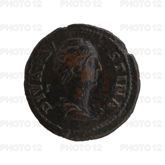 Dupondius/as; bust of Faustina the Elder 98–141; Roman empress 138–141 in drapery facing right; inscription DIVA FAV•STINA around; reverse: Ceres standing right, holding a long torch in her right hand and ears of corn in her lowered left hand; inscription A VG•VST•A all around in SC. fields; posthumous issue of Antoninus Pius 86–161; Roman emperor 138–161, Roman Empire, after 141; bronze coin; diameter 27.0–27.5 mm; weight 9.90 g; axis 180°., A round, worn coin with a raised profile of a head facing right in the center, showing textured hair and facial features; the coin surface is uneven and pitted with areas of darker and lighter wear. The coin displays a mix of dark brown and black tones with patches of lighter brown where the raised details catch light, and small hints of green oxidation in a few spots. The rim is irregular and shows a beaded border around much of the edge, and the overall appearance is aged and corroded.