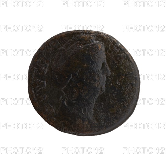Dupondius/as; Faustina the Elder 98–141; Roman empress 138–141 posthumously and Antoninus Pius 86–161; Roman emperor 138–161 issuer. Roman deities; Faustina the Elder — iconography. Torches; palladium attribute; Vesta mythology. Draped bust of Faustina I facing right, legend DIVA FAVSTINA around; reverse: Vesta standing left, holding a statuette of Athena palladium in her outstretched right hand and a long torch in her left, legend AVGVSTA around, in SC fields. After 141 CE, Roman Empire; Rome mint. Coin; diameter obverse 24.5 mm, reverse 26.0 mm; weight 11.00 g; axis 180°., A round dark coin with a worn raised profile of a person visible on one side, showing textured, uneven surface and patina; colors include dark brown, black, and hints of rusty brown, with some glossy and matte areas across the coin.