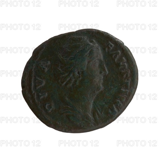 Silver dupondius/as, after 141, Rome. Obverse: Bust of Faustina the Elder in drapery facing right, inscription DIVA FAVSTINA. Reverse: Vesta standing left, holding a statuette of Athena palladium in her outstretched right hand and a long torch in her left, inscription AVGVSTA all around, in SC. Roman deities; palladium attribute. Coin; diameters 24.5 mm and 28.5 mm, weight 10.90 g, axis 195°. Makers: Faustina the Elder posthumously and Antoninus Pius issuer, Roman Empire 27 BC–476., A round dark green and brown patinated coin with a raised profile of a person's head facing right, surrounded by a faint raised rim and subtle worn details across the surface.