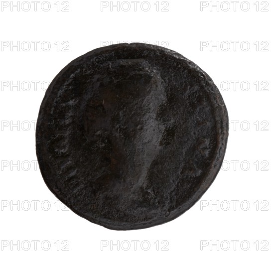 as/dupondius; Faustina the Elder 98–141; Roman empress 138–141 posthumously; Antoninus Pius 86–161; Roman emperor 138–161 issuer; Roman deities, Vesta; pateras; altars; Faustina the Elder — iconography; torches. Obverse: Bust of Faustina I in drapery facing right, DIVA FAV-STINA around. Reverse: Vesta standing left, holding a patera above an altar in her outstretched right hand and a long torch in her left, CONSE-CRATIO around, in SC. fields. After 141. Roman Empire; Rome. Coin as/dupondius; diameter 26.5–27.5 mm; weight 9.85 g; axis 180°., A round, dark object with a rough, uneven surface and a slightly raised central area, showing varied textures and shallow contours; the object appears mostly black with hints of dark brown and subtle grayish reflections.
