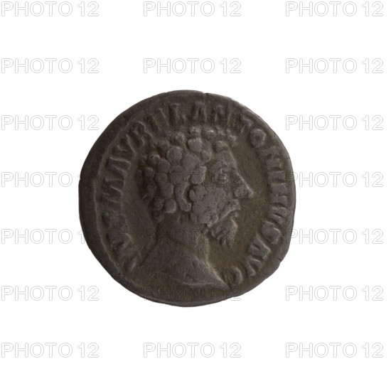 Denarius of Marcus Aurelius 121–180; Roman emperor 161–180. Obverse: Head of Marcus Aurelius uncovered, facing right; legend IMP M AVREL ANTONINVS AVG. Reverse: Providentia standing left, holding a globe in her right hand and a cornucopia in her left; legend PROV DEOR TR P XVI COS III. Date: 161–162. Place: Rome. Type: coin denarius. Diameter: 17.0 mm. Weight: 2.55 g. Axis: 180 degrees., A round, dark gray coin with a raised profile of a man's head facing right; the head shows textured hair and a beard. The coin's rim is slightly irregular and the surface has worn, matte areas with subtle variations of darker and lighter gray. There is a ring of raised, irregular shapes around the inner edge of the coin. The overall visible colors are shades of gray and dark gray.