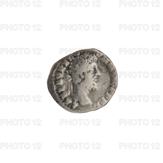 Denarius of Commodus reigned 177–192. Obverse: Head of Commodus in a laurel wreath facing right, legend L AEL AVREL C - OMM AVG P FEL. Reverse: Fortuna Felix standing left, holding a cornucopia in his left hand and a caduceus in his right, resting a leg on a ship, a star in the left field; legend P M TRP XVII IMP VIII COS VII PP. Date: 192. Roman Empire; mint: Rome. Bronze/metal coin; diameter c.15–17 mm, weight 2.40 g, axis 180°. Iconography: Roman deities Fortuna, caduceus, ships, stars, cornucopias; issuer: Commodus., A small circular metallic object with a worn, uneven edge showing a raised profile of a person in relief; the surface has textured, irregular indentations and a rim with a series of short raised marks. The object appears in shades of gray and silver against a white background.