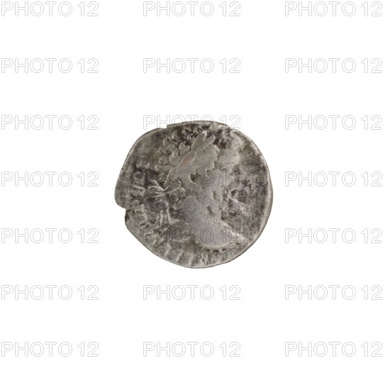 Denarius of Septimius Severus 146–211; Roman emperor 193–211. Obverse: bust of Septimius Severus issuer, ruler. Reverse: Roman deities, wreaths, Victoria, palm branches. Iconography of Septimius Severus. Date: 197–198, Rome, Roman Empire 27 BC–476. Medium: coin. Diameter: 15.5–16.5 mm. Weight: 2.76 g., A worn circular metal object with an uneven edge, showing a raised profile shape and surrounding raised decorative elements; the surface appears textured with areas of smooth wear and darker recessed spots. The visible colors are silver-gray with darker gray and faint brownish tones.