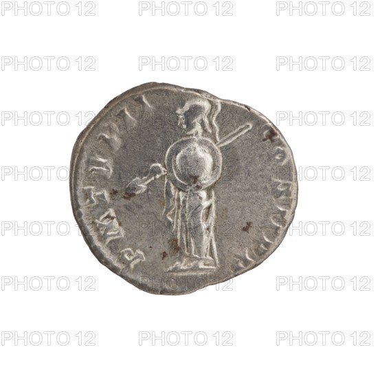 Denarius, Septimius Severus 146–211; Roman emperor 193–211 issuer. Obverse: Head of Septimius Severus in a laurel wreath facing right, legend L SEPT SEV PE - RT AVG IMP IIII. Reverse: Minerva standing left, holding a spear pointing forward and downwards in her right hand and a round shield in her left, legend P M TR P II - COS II PP. Date: 194–195. Place: Rome, Roman Empire. Type: coin denarius. Diameter: 16.0–18.0 mm. Weight: 2.75 g. Axis: 180°., A circular metallic object with a worn, uneven edge showing a raised, sculpted figure in profile standing and holding a round shield and a staff, with visible surface scratches and small dark spots; the object appears mostly silver-gray with areas of darker gray and a few brownish discolorations, set against a plain white background.