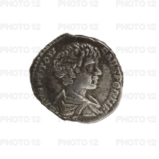 Denarius of Septimius Severus 146–211; Roman emperor 193–211 and Caracalla 188–217; Roman emperor 198–217 Caesar. Obverse: M AVR ANTON CAES PONTIF, bust of Caesar in cloak facing right. Reverse: MARTI VLTORI, Mars striding right, holding a spear and a trophy. Dated 196–198, Roman Empire. Coin; diameter ~16.5–18.0 mm; weight 3.47 g., A weathered round coin with an uneven edge showing a profile of a person facing right, with short curly hair and a visible ear, a neck and upper chest draped in cloth; the coin surface is textured with worn relief and patina in shades of dark gray, silver, and hints of brown, set against a white background.