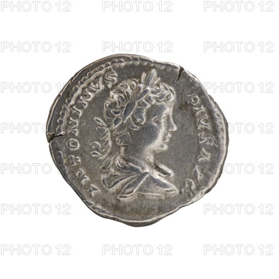 Denarius, Caracalla reign 198–217; emperor 188–217. Obverse: ANTONINVS PIVS AVG, bust of young Caracalla with laurel wreath, cloak and armour, facing right. Reverse: PART MAX PONT TR P IIII, trophy with seated bound prisoners beneath. Roman Empire, Rome, 201 CE. Coin; diameter ~18.0–19.5 mm; weight 3.17 g., A worn round metallic coin with a raised profile of a person facing right in the center, showing detailed hair and a laurel-style headpiece and draped clothing; the coin surface is mostly silver-gray with darker gray areas in recessed parts and some lighter highlights on raised features; the rim is irregular with a few small chips and cracks visible, and there is subtle surface texture showing wear and slight tarnish.