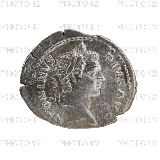 Denarius of Caracalla reign 198–217 CE. Obverse: laureate head of Caracalla facing right with legend ANTONINVS PIVS AVG. Reverse: legend LAETITIA TEMPORVM; ship with animals running around and four quadrigae in the background. Rome; dated ca. 206–210. Bronze/metal coin; diameter ~18.5–22.0 mm; weight 3.14 g., A worn metallic coin with a circular shape and irregular, slightly chipped edges shows the profile of a person facing right with visible facial features and a laurel-like headpiece; the surface has textured, scuffed areas and raised relief details suggesting hair and clothing, and the coin displays a few cracks and dents around its rim. The visible colors are silver-gray with darker gray tarnish and lighter silvery highlights.