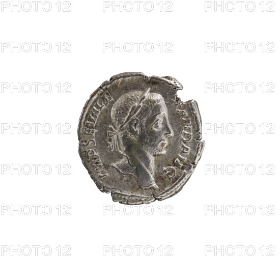 Denarius of Alexander Severus emperor 222–235 CE, 229 CE, Rome. Obverse: portrait of Alexander Severus iconography, ruler. Reverse: personification Libertas. Roman Empire 27 BCE–476 CE. Coin; diameter approx. 18.5–19.0 mm; weight 2.65 g., A worn round metallic object with an irregular edge showing chips and indentations, featuring a raised profile of a person's head facing right with short textured hair and a headband, a visible neck and shoulder, and faint raised decorative elements around the rim; dominant colors are silver and gray with small areas of darker tarnish and subtle greenish spots.
