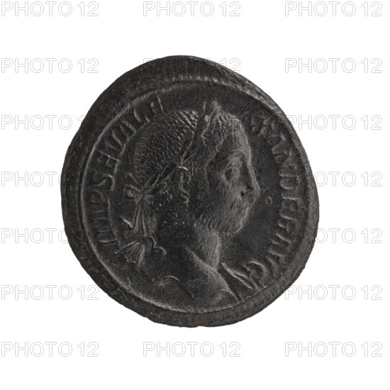 Personifications; Libertas personification; Alexander Severus Roman emperor; 222–235 — iconography; Roman Empire 27 BC–476; Rome; coin; diameter 26.0 mm; diameter 28.0 mm; weight 11.73 g, A dark, round coin with a raised rim occupies the center of the image against a white background; the coin appears mostly black and dark gray with textured, worn surfaces, and shows a right-facing bust of a person with short, textured hair and a tied ribbon or band at the back of the head, along with a suggestion of shoulders and drapery below the neck.