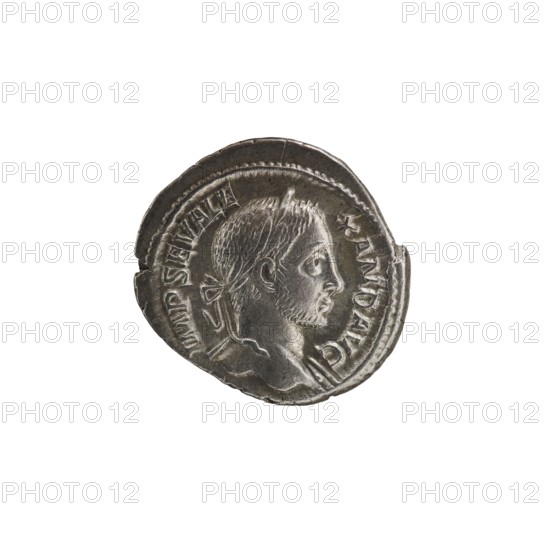 Denarius of Alexander Severus Roman emperor, 222–235. Obverse iconography: standing emperor with spears and globes. Date: 230. Place of origin: Rome, Roman Empire 27 BC–476. Medium: coin. Measurements: diameter 18.0 mm and 20.5 mm; weight 3.99 g., A round metallic coin with a worn surface showing a profile of a man's head facing right, featuring short hair, a tied ribbon at the back, and a short beard; the coin's edge is irregular and slightly damaged in places, and there is raised decorative rim detail around the portrait. The visible colors are silver, gray, and darker gray tones.