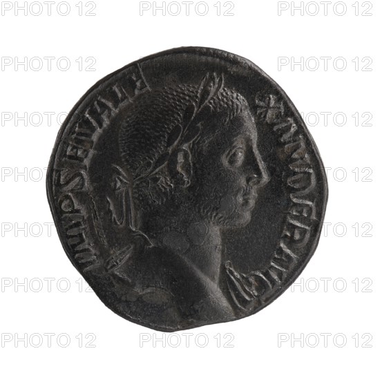 Sestertius; Sol mythology; Alexander Severus Roman emperor, 222–235 — iconography, Roman deities; 230; Rome; Roman Empire 27 BC–476; coin; diameter 29.5–30.0 mm; weight 19.44 g, A round dark metal coin with a raised profile of a person facing right, showing facial features, short textured hair, an ear, and a laurel or leafy wreath around the head, with a draped garment visible on the shoulder; the coin surface is worn and uneven with raised rim and shallow relief details. Colors visible include dark gray, black, and subtle highlights of lighter gray.