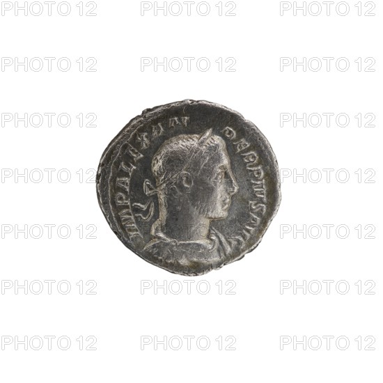 Denarius of Alexander Severus Roman emperor, 222–235 CE, issuer: Alexander Severus. Obverse iconography: Roman deities; portrait of Alexander Severus. Reverse iconography: Jupiter mythology. Date: 231–235 CE. Place of origin: Rome, Roman Empire. Material: coin; diameter: 18.0 mm and 19.5 mm; weight: 3.01 g., A round metallic coin with a worn, textured surface showing a raised profile of a person's head facing right; the head has short hair and a tied band at the back, and the neck and shoulders are visible with draped clothing. The coin's rim is irregular and slightly dented, and there is raised detailing and shallow relief around the portrait. The visible colors are metallic gray with darker gray areas in crevices and a few lighter silver highlights on raised surfaces.