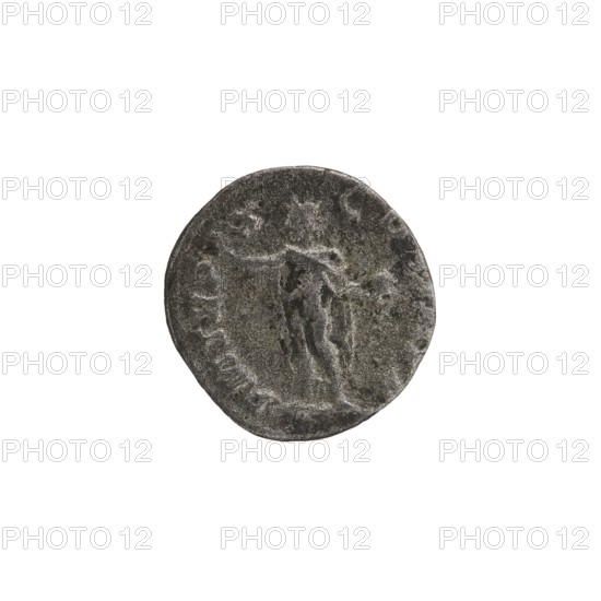 Denarius depicting Roman deities: Sol; obverse associated with Emperor Alexander Severus reign 222–235, iconography dated 231 CE. Roman Empire 27 BCE–476 CE; mint: Rome. Coin; diameter ~17.0–18.0 mm; weight 2.98 g., A circular, worn metallic object with a rough textured surface in shades of gray and dark gray, showing the faint raised outline of a standing human figure in the center; the object has irregular edges and a slightly darker rim with uneven discoloration and mottled patches of lighter gray.