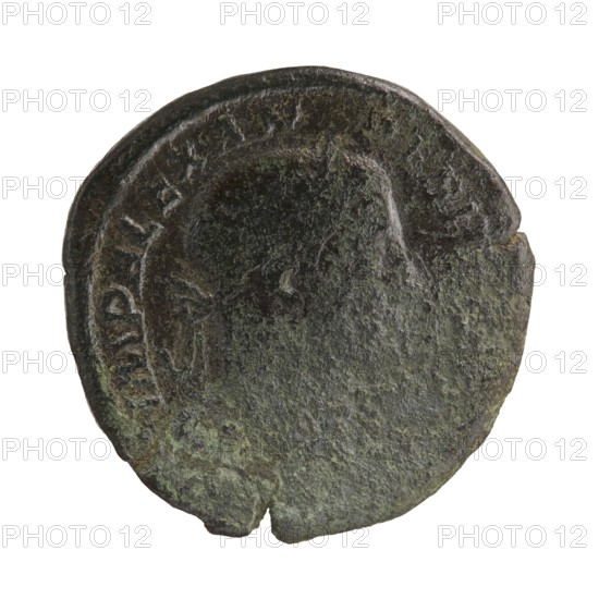 Sestertius of Severus Alexander Roman emperor 222–235, struck 231–235 CE. Obverse: portrait of Severus Alexander issuer. Reverse: personification of Providentia. Roman Empire; mint: Rome. Bronze coin; diameters 27.5–30.0 mm, weight 15.35 g., A circular metal object with a worn, textured surface showing areas of dark brown, green, and gray patina, with an irregular edge and a small notch at the rim; the surface displays the faint raised outline of a profile and a surrounding raised border with shallow worn details.