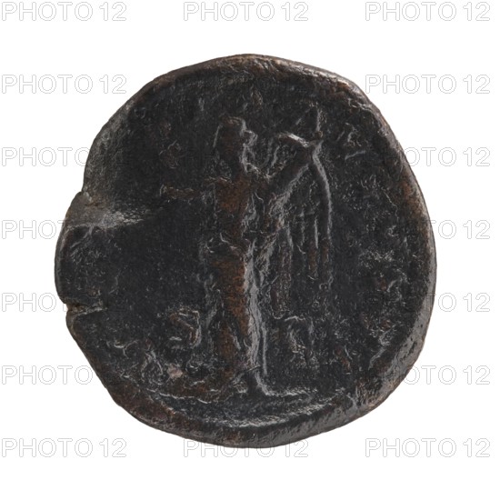 Sestertius; obverse: Alexander Severus Roman emperor; reign 222–235; reverse: Victoria mythology; iconography of Roman deities; dated 228–231 CE; Roman Empire 27 BC–476; mint: Rome; coin; diameter 29.5–30.5 mm; weight 16.48 g., A dark round object with an uneven, worn surface and a raised central area that suggests a faint outline of a standing human-like figure; the object shows smooth and rough textures, small pits and scratches, and an irregular edge with a shallow notch on one side; visible colors include dark brown, black, and hints of rust-colored brown.