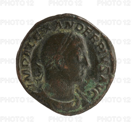 Sestertius of Severus Alexander reigned 222–235 CE. Obverse: issuer Severus Alexander with imperial titles; Reverse: Roman deity Sol iconography. Roman Empire, Rome, 233 CE. Coin; diameter 28.0–30.5 mm; weight 21.33 g., A round, worn coin with an aged, uneven surface showing a raised profile of a person's head in relief; the coin displays a mix of dark brown and black tones with patches of green and lighter brown patina, and the raised rim and edges appear irregular and slightly rough.