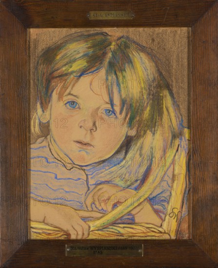 Portrait of a Child, Stanislaw Wyspianski 1869–1907, ca. 1901, pastel, 31 × 24 cm., A framed pastel portrait of a young child with blue eyes and light skin, shown from the shoulders up and looking toward the viewer; the child has long hair with visible streaks of yellow, green, blue, and brown, and a solemn facial expression. The child wears a striped garment with blue lines on a light background, and hands rest on a woven surface with yellow and brown tones. The background is a textured brown, and the frame is dark wood with small metal plaques at the top and bottom.