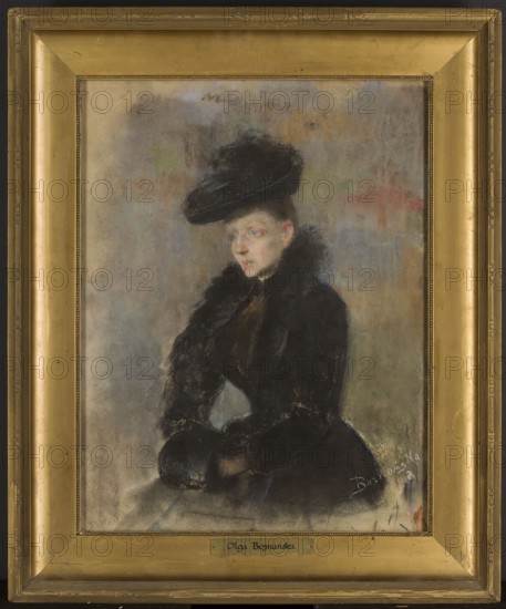 Portrait of a woman in a black hat; verso: sketch of a girl's portrait. Olga Boznanska 1865–1940, 1892. Pastel, 47.5 × 36 cm. Style: Young Poland; subject: portrait of a woman; category: portraits, Polish painting., A framed portrait of a seated woman wearing a dark outfit and a large dark hat, rendered with soft, muted pastels; the woman has a pale complexion with visible blue eyes and light hair at her temples, and she appears in three-quarter view with hands clasped in her lap holding a round dark muff. The background is a blend of muted gray, beige, and faint warm tones with subtle green and pinkish areas, and the frame is a warm gold color with a beaded inner edge and wider outer molding showing some wear. The woman’s clothing and hat are mainly black and deep brown with textured fur details, and there are touches of lighter gray and blue in shadows and on the lower part of the composition.