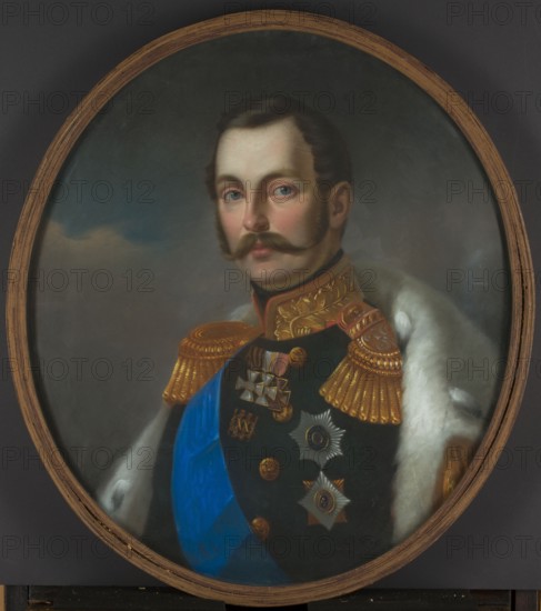 Portrait of Tsar Alexander II, by Tytus Maleszewski 1827–1898, pastelist; 1856. Pastel on paper, 75.5 × 65 cm. Bust portrait of Alexander II 1818–1881 in uniform with orders, fur trim; Polish pastel, Romanov ruler, male portrait., An oval framed portrait of a man shown from the chest up wearing a dark military-style coat with ornate gold epaulettes and decorative gold embroidery at the collar, a bright blue sash across his chest, and a white fur-trimmed cloak draped over one shoulder; the man has fair skin, brown hair, a full mustache, and blue eyes with a neutral expression; several metallic medals and star-shaped insignia are pinned to his coat; the background is a muted, cloudy mix of gray and blue tones and the frame is a warm wood color.