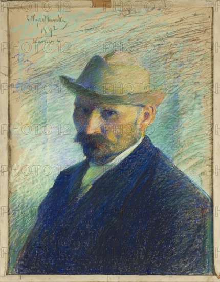 Self-portrait by Leon Wyczólkowski 1852–1936, pastel, 1892; portrait of a male; impressionist style; height 66.5 cm, width 52.5 cm; Poland., A portrait of a man shown from the chest up wearing a tan-brown hat and a dark blue jacket, with a darker beard and mustache and visible skin tones on his face and ear; the background consists of energetic, diagonal pastel strokes in shades of light blue, aqua, green, and tan, with areas of darker blue and purple near the figure; the man's shirt collar is a lighter color with a hint of green, and the overall image is framed by a beige border.