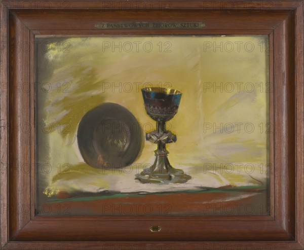 Chalice of Bishop Padniewski, painter Leon Wyczólkowski 1852–1936 after Filip Padniewski 1510–1572. Gothic and Renaissance goldsmithery; liturgical vessel. Young Poland style; pastel, 1907. Polish painting. Dimensions: height 42.5 cm, width 55.5 cm., A framed painting shows a still life with a chalice and a round plate placed on a cloth; the chalice has metallic reflective surfaces with dark and golden highlights and a stem with a decorative cross-like element, while the plate is dark gray to black with subtle brownish reflections; the background and cloth are rendered in shades of yellow, pale green, and muted beige with strokes of light purple and white, and there are accents of brown, reddish brown, and a thin green line near the lower edge; the frame is wooden in warm brown tones.