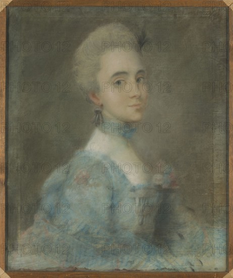 Portrait of Franciszka Krasinska, women's portrait, Krasinska, Franciszka Duchess of Courland; 1742–1796 — iconography; women's fashion; aristocracy; rococo painting; ca. 1760; pastel; height 64.5 cm, width 54.5 cm;, A portrait of a woman shown from the shoulders up, turned slightly to her left, wearing a pale blue dress with lace details and floral accents; her hair is light and styled up, and she has a small dark earring and a blue ribbon or choker at her neck. The background is a muted gray-green, and the painting is enclosed by a wooden frame with visible grain in brown tones. The palette includes pale skin tones, light blond hair, various shades of blue in the clothing, muted pinks in the floral accents, dark gray in the earring and feather, and overall gray-green in the background.