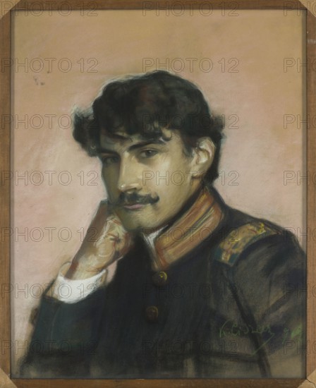 Portrait of a Soldier, Karol Ciszewski 1874–1926, painter; male portrait of a soldier; pastel; 1904; Poland; unknown provenance., A portrait of a man with dark wavy hair and a dark mustache, shown from the chest up against a pale peach background; he rests his chin on a hand with a visible white cuff, wearing a dark uniform jacket with a high collar featuring warm brown and gold accents and decorative shoulder details, and the image is set within a simple wooden frame with warm brown tones.