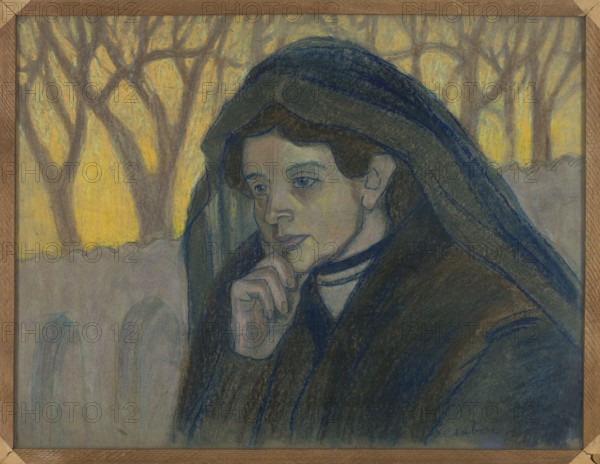 Woman in Mourning, Jan Rembowski 1879–1923. After 1905. Pastel on paper, 52.5 × 70.0 cm. Female portrait depicting Alina Bondy-Glassowa 1865–1935 in mourning; symbolism; Young Poland style; Polish drawing; portrait., A portrait of a person wearing a dark hooded cloak, resting a hand against their chin in a contemplative pose; the face shows pale skin tones with muted blue and green shading and dark hair partially visible under the hood, with a neutral expression and softly defined features. The cloak and hood display deep blues, dark grays, and touches of brown, with layered shading suggesting heavy fabric. The background contains a muted yellow glow behind a group of leafless tree trunks and branches drawn in grayish brown, and a pale lavender-gray wall or ledge in front of the trees. In the lower area, there are arches suggested in soft bluish-gray and faint green tones. The overall palette includes yellow, blue, gray, brown, green, and pale skin tones, with a simple wooden frame vis...