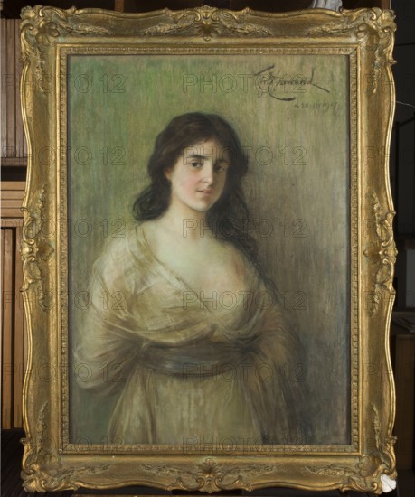 Portrait of a Young Woman, Ejsmond, Franciszek 1859–1931, painter; female portrait; pastel; 1907; Warsaw; height 95 cm, width 68.5 cm; Polish pastels; Masters of Pastel; From Marteau to Witkacy., A framed oil portrait of a young woman with long dark hair wearing a pale, semi-sheer dress with a sash, depicted from the waist up against a muted green-gray background; the woman has a neutral expression and slightly turned head, and the ornate frame is gold with decorative floral and scroll details.