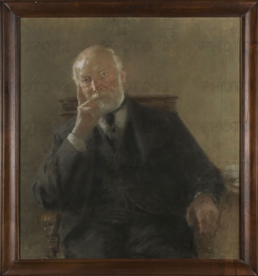 Portrait of Professor Antoni Malecki, by Zdzislaw Jasinski 1863–1932. Subject: Antoni Malecki 1821–1913. Date: 1899. Medium: pastel. Dimensions: height 99 cm, width 90 cm. Genre: male portrait, scholar; sitting figure. Polish., A framed painted portrait of an older man seated in a chair, shown from torso upward. He has pale skin, a white beard and mustache, and thinning white hair. His facial expression appears contemplative with a hand resting against his cheek. He wears a dark suit and light-colored shirt with a dark tie. The chair has wooden elements visible behind him and a wooden arm that his other hand rests on. The background is a muted, neutral tone in shades of gray and beige. The picture is set in a dark brown wooden frame. Colors visible include brown, dark gray, black, beige, pale pinkish skin tones, white, and hints of muted green.