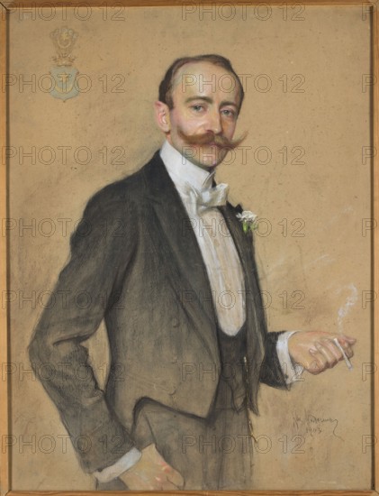 Portrait of Lukasz Dobrzanski, Mordasewicz, Kazimierz 1859–1923 painter, Lukasz Dobrzanski 1864–1909 — male portrait; iconography of Lukasz Dobrzanski 1864–1909; coats of arms: Leliwa; Poland culture; cigarettes, nicotine; Polish pastels; Masters of Pastel; 1903, Warsaw; pastel drawing; height 107 cm, width 77.5 cm, A portrait of a man standing against a plain tan background, wearing a dark suit with a white shirt and bow tie, a waistcoat, and a small white boutonniere; he has light skin, a styled brown mustache, slicked dark hair, and a neutral expression while holding a lit cigarette with pale smoke in one hand; a group of decorative emblem shapes appears in the upper corner, and the image is bordered by a thin wooden frame with brown and golden tones.