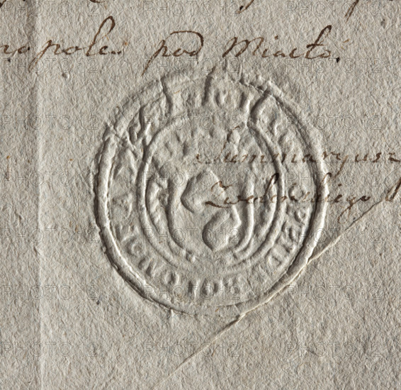 Oval seal impression of the town of Bolimów, Lódz Voivodeship, Sochaczew Land. On the crowned shield, two identical objects strung on a stick. Inscription around the rim: SIGILLUM OPPIDI BOLOMOF AD 1443. Date: 1443. Seal dimensions: 37 mm and 40 mm. Materials: seal impression. Style: city/state seal, coat of arms. Maker: unknown.