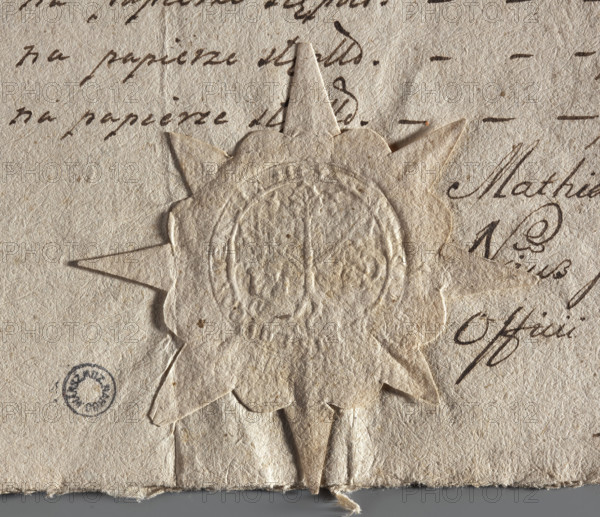 Round seal impression of the town of Buk, Poznan Voivodeship and County. A tree with three roots and three branches ending in leaves intersects a key. Illegible inscription on the rim. 1777, Poland.
