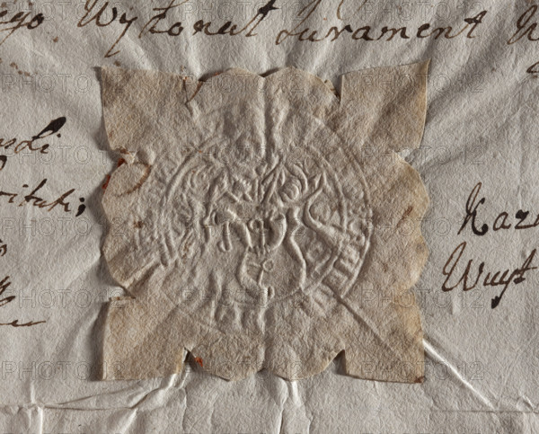 Round seal impression of the town of Dukla, Kraków Voivodeship. Figure of Saint John the Baptist holding a shield with the Traby coat of arms. Illegible inscription on the rim. 1748, Poland.