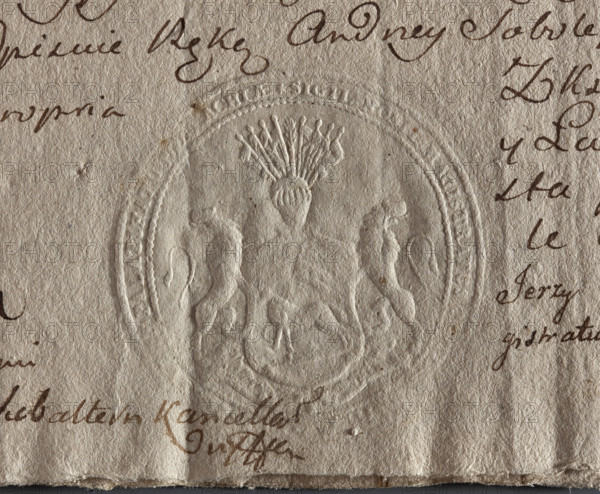 Round seal impression of the town of Kleszczele, Podlaskie Voivodeship. A shield supported by two lions, with a lamb turned to the right with a banner. Above the shield, a helmet with nine banners. An illegible inscription on the rim. Date: 1790. Poland. Seal; town seal of Kleszczele; official seal with coat of arms. Maker: Zurakowski, Witold (?-1927). Document seal; round impression.