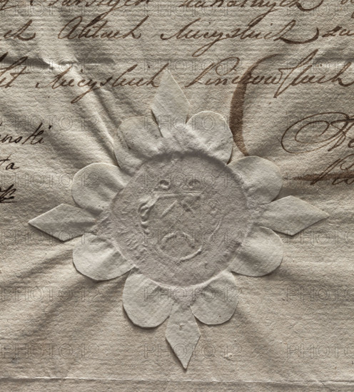 Round seal impression of the town of Pinczów. On a shield decorated with labres, a split rogacina, torn at the bottom — the halved Ogonczyk coat of arms. Illegible inscription on the rim. 1791, Poland.