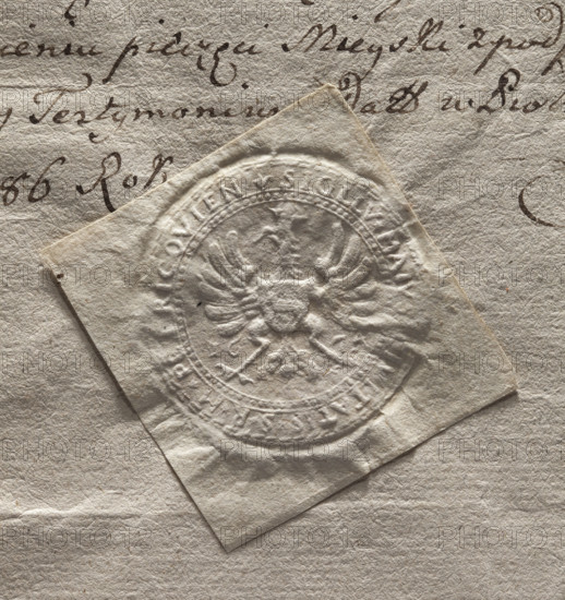 Round seal impression of the town of Piotrków. A crowned eagle with a shield bearing the Ciolek coat of arms on its chest. Date: 1674. Inscription around the rim: SIGILLUM MAIUS CIVITATIS S R M PETRICOVIEN. Poland. WQXBCFS