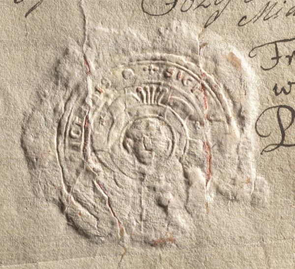 Round seal impression of the town of Proszowice, Kraków Voivodeship. In a round, baroque cartouche with five feathers forming a jewel an illegible drawing of St. John's head on a bowl. In the rim is the inscription: SIGILLUM, ICENSIS., 1777. City seal of the town of Proszowice; seals with the city coat of arms; state seal with coat of arms; document seal; round seal impression; Poland., A close-up of textured beige paper showing an embossed circular seal with a raised profile of a human head at its center and concentric decorative rings around it; the seal area has several creases and torn edges revealing faint reddish-brown remnants, and there is flowing dark ink handwriting partially visible at the edges; overall colors include beige, off-white, reddish-brown, and dark brown.