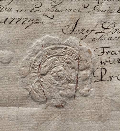 Round seal impression of the town of Proszowice, Kraków Voivodeship. In a round, baroque cartouche with five feathers forming a jewel an illegible drawing of St. John's head on a bowl. In the rim is the inscription: SIGILLUM, ICENSIS., 1777. Poland.