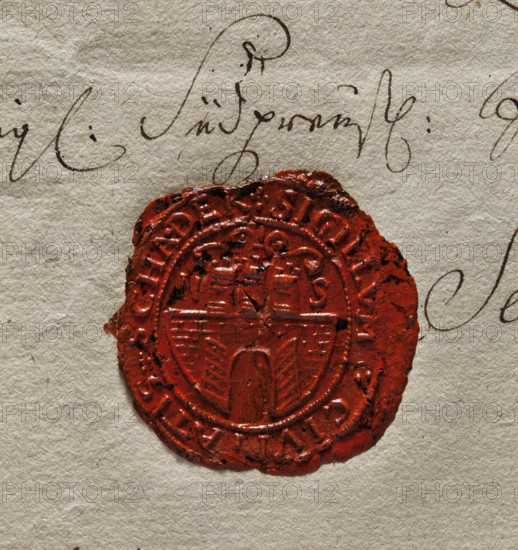 Oval wax impression of the seal of Szadek. Town wall with an open gate, on it three towers with battlements. On the sides the letters N S. Inscription around the rim: + SIGILLUM + CIVITATIS + SCHADEK +. 1782. Poland. Seal. Dimensions: 31.5 mm and 35 mm.