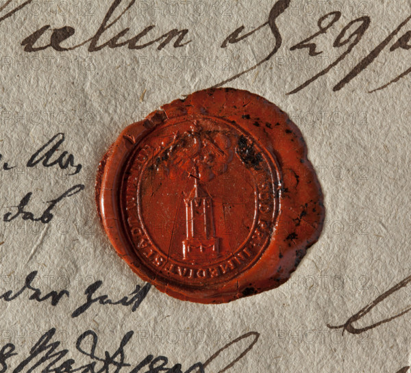 Oval wax seal of the city of Wielun. Obelisk on a pedestal decorated with garlands; a banner atop. Above the obelisk in the clouds is a Prussian eagle. Inscription around the rim: KON. SUD. PR. INMEDIAT. STADT. WIELUN. Dated 1802. Poland. Seal. Dimensions: 25 mm × 27.5 mm. WQXBCFS