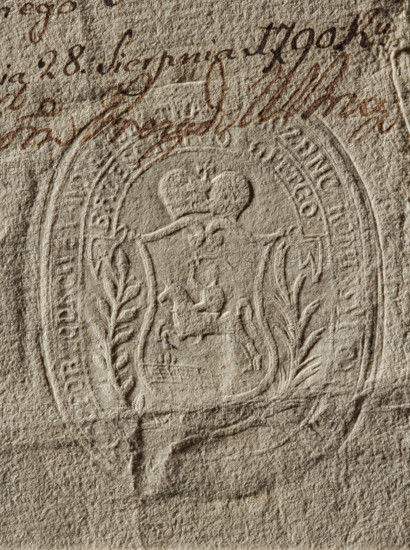 Oval imprint of the seal of the Civil-Military Order Commission in Brest-Litovsk. On the decorative shield, under the mitre, the Pogon coat of arms. Under the shield, the date: 1789. Two branches around the shield. Around the rim is the inscription: PIECZENC KOMISSYI CYWILNO, PORZADKOWEY WOIE, // BRZESKIEGO . LITTGO., 1789. Seal, Poland., The image shows a close-up of textured paper in beige and light brown tones with an embossed oval seal featuring a central shield topped by a heart-shaped element and flanked by leafy motifs, surrounded by decorative borders; there is a smudged area of darker brown ink near the top with looping cursive strokes, and the paper surface displays visible fibers, creases, and subtle shadows that emphasize the raised and pressed details.