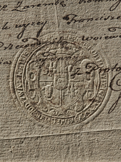 Round seal impression of the Civil-Military Order Commission of the Kalisz Voivodeship. Oval crowned 5-field shield; in the heart-shaped field the Ciolek coat of arms; in fields 1 and 4 an eagle; in fields 2 and 3 the Wieniawa coat of arms — coat of arms of the voivodeship. Inscription on the rim: 'KOMMISSYI CYWILNO WOYSKOWEI WOIEVODZTWA KALISKIEGO'. 1792, Poland, stamp., A close-up of textured beige paper showing an embossed circular seal with a detailed coat of arms in the center, surrounded by decorative concentric rings and ornamental flourishes; the seal appears pressed into the paper, creating raised and recessed areas that cast subtle shadows. A few sections of dark brown handwritten ink strokes curve and cross near and over parts of the seal, with several flowing, cursive marks visible against the paper. The overall color palette includes shades of beige, tan, and brown, with the paper’s fibrous surface and tiny irregularities visible throughout.