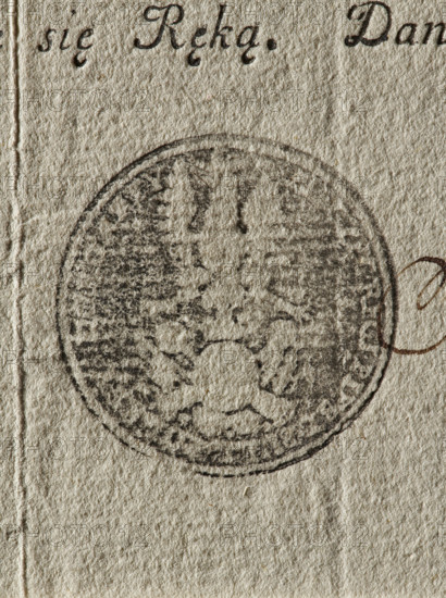 Seal of the Infantry Regiment of the Crown Field Bulawa, Military Commission of the Two Nations; round ink print of the seal. An eagle with a crown above a round shield with an illegible coat of arms, behind the shield a panoply. In the rim the inscription: 'PIECZEC REGI. PIESZ. BULL. PONLEY KORONNEY.' The document is a print, stamped and signed, but not filled out. 18th century, Poland., The image shows a close-up of textured off-white paper with a faded circular stamp in dark gray or black ink near the center, showing an indistinct emblem-like pattern. The paper surface has visible fibers and creases in beige and light tan tones, with a small curved brown ink mark near the right edge of the stamp and a few darker gray smudges around the stamp area. The overall colors visible are off-white, beige, light tan, dark gray or black, and brown.