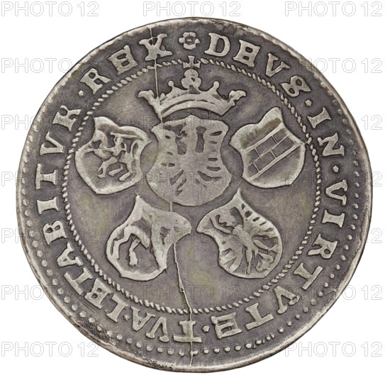 Majnert's forgery of a crown thaler, Sigismund I the Old (King of Poland; 1506–1548), Majnert, Gotfryd (1767–1846); Obv.: bust of Sigismund I in a cap, crown and armor, turned right, inscription around the rim: SIGISMVNDVS.PRIM.REX.POLONIE 15 29; Reverse: Polish coat of arms under a crown surrounded by Sforza coats of arms, Ruthenia, Prussia and Lithuania, inscription around the rim: DEVS.IN.VIRTVTE.TVA.LETABITVR.REX; 1529 (false, made in 1836); Poland; coin; diameter 43.4 mm; weight 26.87 g, A circular metal coin with a worn, aged surface showing a central shield-like emblem topped by a crown and surrounded by several smaller shield shapes arranged around it; the coin’s rim is decorated with a beaded inner border and raised lettering along the outer edge that contrasts with the darker recessed background; the metal displays a mix of gray and silver tones with darker tarnished areas and a few greenish patina spots, and there is a visible hairline crack running across the coin from near...