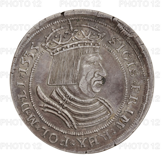 Majnert's forgery of the crown thaler of Sigismund I the Old (King of Poland; 1506–1548), by Gotfryd Majnert (1767–1846). Obverse: bust of Sigismund I in a bonnet and crown facing right; in the rim an inscription divided by coats of arms: 'SIGISM P REX PO LONIE MD LITHV 1535'. Reverse: under the crown, a five-field coat of arms with the arms of Poland, Lithuania, Royal Prussia, Ruthenia and Austria. 1535. Poland. Coin. Diameter 42.0 mm; weight 26.77 g., A round metallic coin pictured against a white background showing a profile bust of a man facing right wearing a crown and a layered, decorated collar; the coin surface has a worn, textured appearance with scratches and small dents, and the raised portrait and ornamental rim are visible; the colors are shades of gray and silver with darker gray tarnish in recessed areas and slight brownish patina in places.