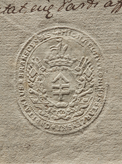 Oval dry impression of the seal of Michal Hieronim Starzenski, Starost of Bransk. The Lis coat of arms with a jewel above a crowned shield, surrounded by a panoply. In the rim an inscription: 'MICHAEL HYERONIMUS STARZENSKI * CAPITANEUS * BRANSCENSIS', dated 1767. Poland; seal. Dimensions: 42.3 mm and 49.2 mm., A circular embossed seal pressed into textured beige paper showing a central shield with a vertical emblem, topped by a crown and flanked by ornate decorative flourishes and scrollwork; the seal has a raised outer ring with decorative motifs and a few small irregularities in the paper fibers; visible colors include beige, off-white, light tan, and subtle darker brown tones in the background handwriting near the top edge.