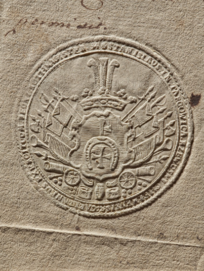 Seal of Stanislaw Ferdynand Rzewuski (1737–1786), starost of Chelm; round dry impression. In the blue field of the shield, the Krzywda coat of arms; behind the shield, rich panoplies. Inscription around the rim: 'STANISLAUS IN TARGOWICA RZEWUSKI CHELMENSIS CAPITANEUS EXERCITUUM ... MAGISTER, 1765.' Poland., A circular embossed seal pressed into coarse beige paper shows an ornate central crest with a crown topped by three tall plume-like shapes, flanked by a group of flags and crossed staffs on each side. Surrounding the crest is a raised circular border with decorative edging and an outer ring containing embossed markings. Within the lower area of the seal are embossed decorative elements resembling wheels, drums, and small rounded shapes. The paper has a textured fibrous surface in shades of beige and light brown, with a small dark brown spot near the right edge and faint darker brown smudges and lines above the seal.